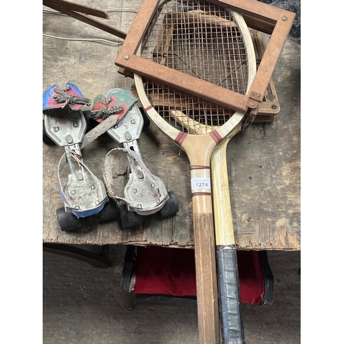 1274 - Two vintage tennis rackets and a pair of vintage Flyer brand quad roller skates