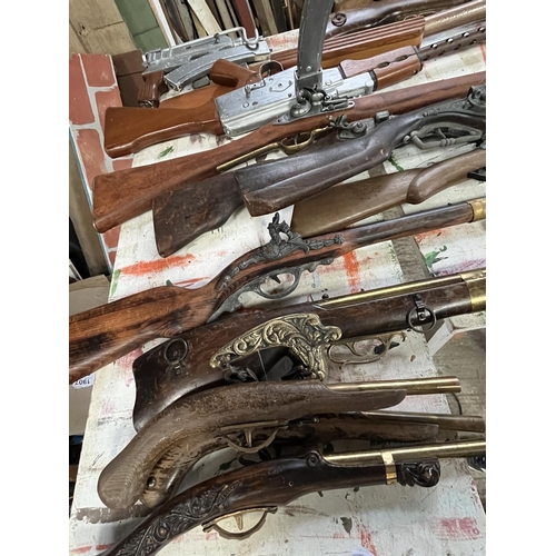 1257 - Quantity of replica/stage prop guns including a shotgun, flintlock pistols, AK-47, blunderbusses, et... 