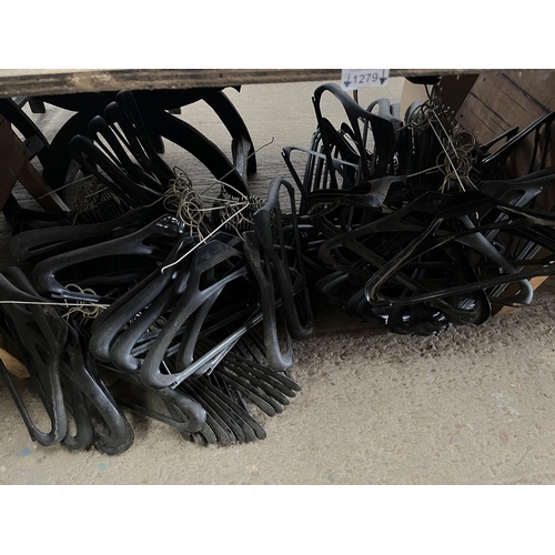 1279 - Large quantity of matching black plastic garment hangers
