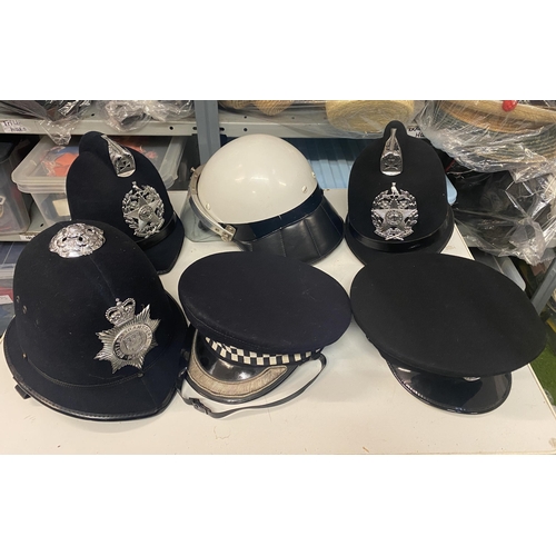 294 - Collection of police helmets/caps (1 bag)