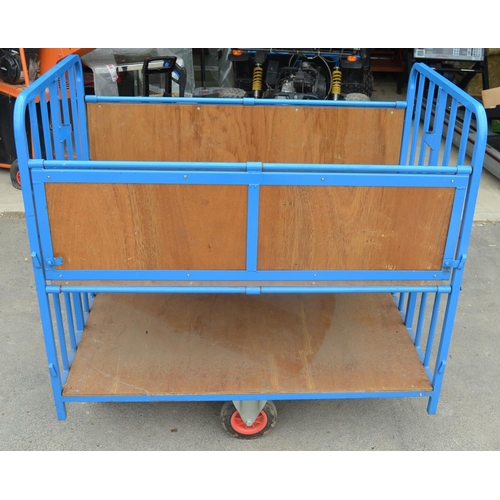 1117 - Four wheel steerable metal trolley with hinged sides, W127cm D76cm H122.4cm