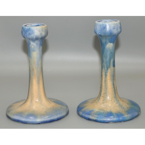 324 - Pair of Ruskin Pottery candlesticks, streaked blue and orange glaze, impressed marks, H16.5cm (2)