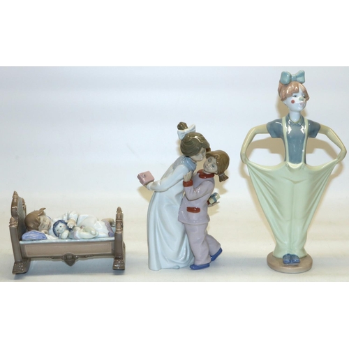 410 - Lladro figure #5717 Rock-a-Bye Baby, H12cm, and two Nao figures including Clowning Ready, H29cm (3)