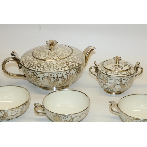 720 - Bavarian type porcelain tea ware with silver overlay, comprising teapot, H11cm, six cups and saucers... 