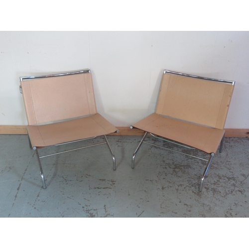 670 - Pair of tubular chromed metal framed low chairs with slung leather seats and backs, W67cm D66cm H70c... 