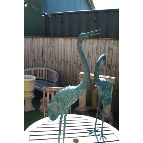 1006 - pair of well cast metal cranes painted with a bronzed effect green H100cm