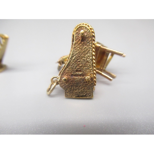 19 - Three 9ct yellow gold charms including harp, chair with guitars and harpsichord, all stamped 375, gr... 