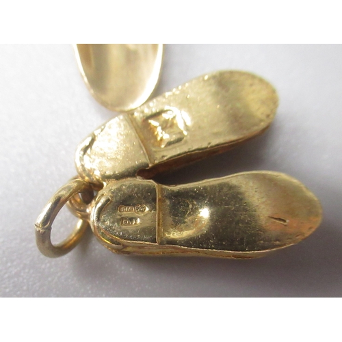 28 - Three 9ct yellow gold charms, including scarecrow, shoes and trowel and fork, all stamped 375, 7.9g