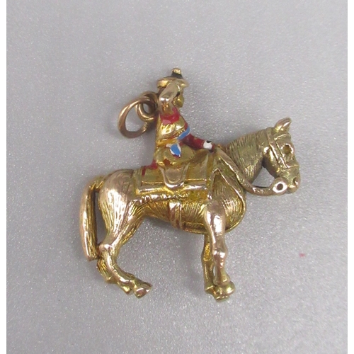 29 - 9ct yellow gold charm depicting the Queen riding a horse,  stamped 375, 7.0g