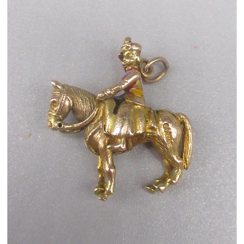 29 - 9ct yellow gold charm depicting the Queen riding a horse,  stamped 375, 7.0g
