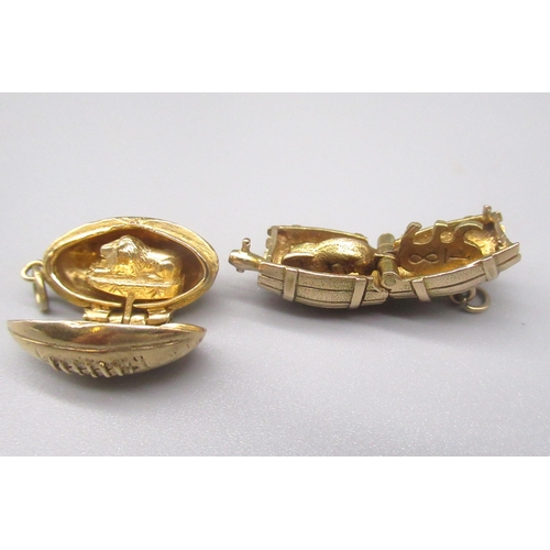 35 - Two 9ct yellow gold opening charms including a rugby ball containing lion and a barrel containing an... 