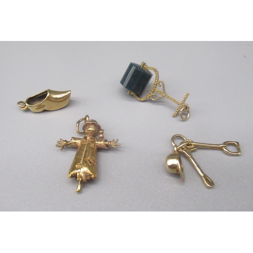 45 - Three 9ct yellow gold charms, including a scarecrow, a clog, helmet and tool, all stamped 375, gross... 