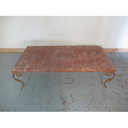 783 - Contemporary coffee table, moulded edge rouge marble top on wrought metal base with four S scroll le... 