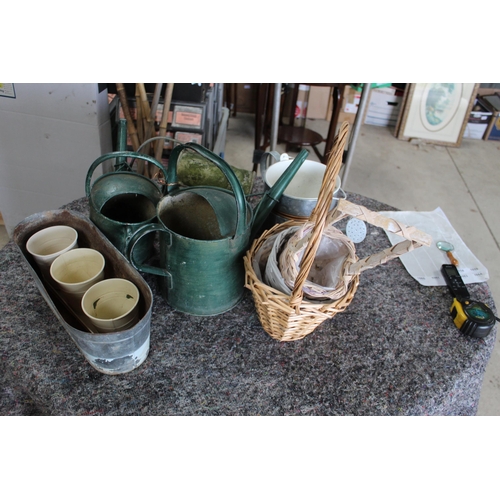 1058 - Collection of watering cans of various styles, wicker baskets, planters, etc.