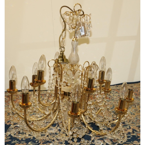 282 - Gilt metal twelve branch chandelier, two tiers hung with prismatic swags, with etched shades