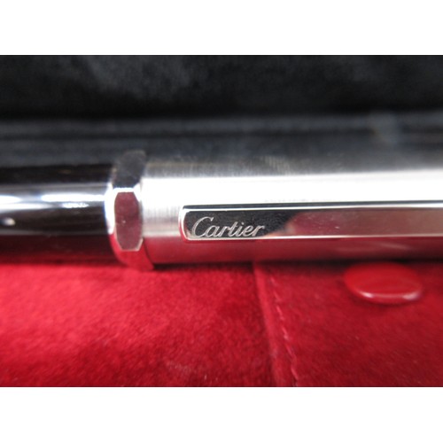 100 - Cartier silver and black ballpoint pen, cased with instructions and certificate, boxed