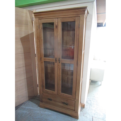 665 - Contemporary oak side cabinet, with two glazed doors above a drawer on bracket feet, W89cm D36cm H19... 