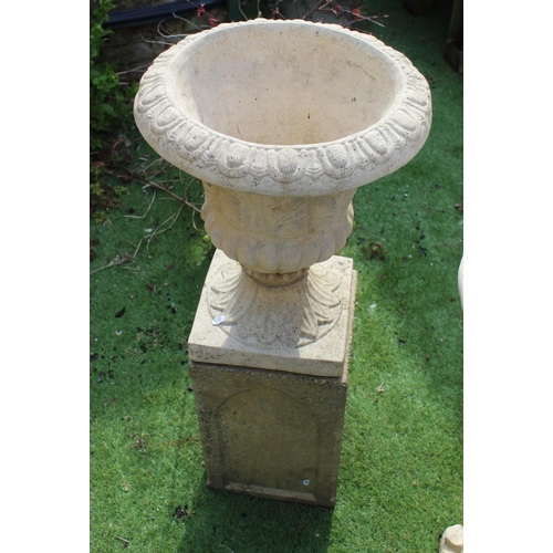 1009 - Reconstituted garden earn with leaf design on square plinth 50cm X 45cm overall height 96cm W 45cm