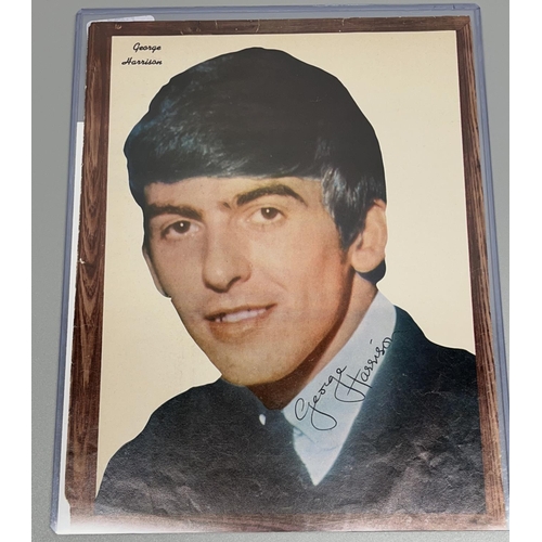 462 - George Harrison magazine page, with signature, 21.3cm x 27.9cm, with Certificate of Authenticity fro... 