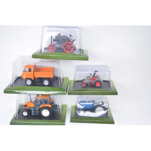 180 - Twenty diecast small scale model tractors/agricultural machinery by Hachette Partworks