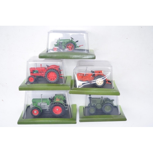 180 - Twenty diecast small scale model tractors/agricultural machinery by Hachette Partworks