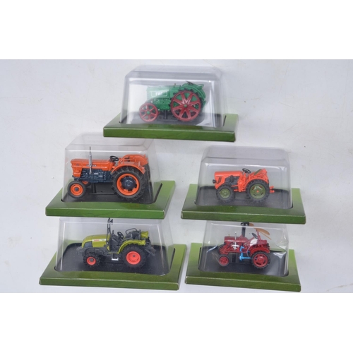 181 - Twenty diecast small scale model tractors/agricultural machinery by Hachette Partworks and 3x Atlas ... 