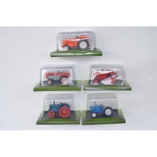 181 - Twenty diecast small scale model tractors/agricultural machinery by Hachette Partworks and 3x Atlas ... 