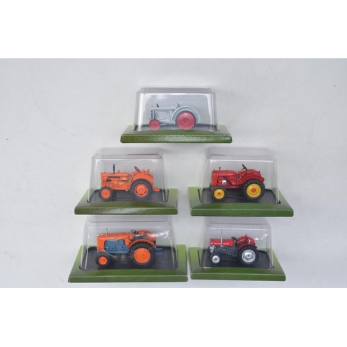 181 - Twenty diecast small scale model tractors/agricultural machinery by Hachette Partworks and 3x Atlas ... 