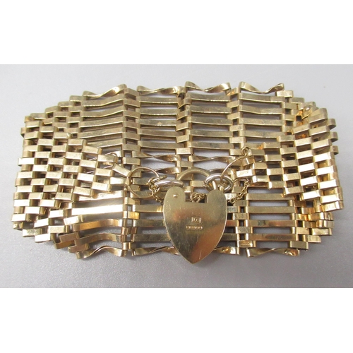 740 - 9ct yellow gold tapering 14 bar gate bracelet, with heart padlock clasp, stamped 375, 24.6g