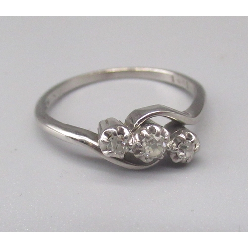 741 - Platinum three stone diamond ring, the brilliant cut illusion set diamonds on twist mount, stamped P... 