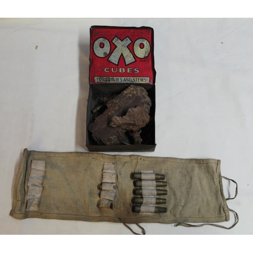 902 - OXO tin containing a collection of shrapnel and a bullet roll