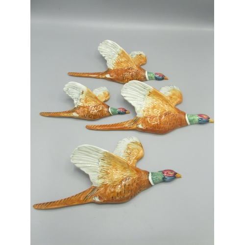 326 - Four Beswick graduated flying Pheasants wall plaques