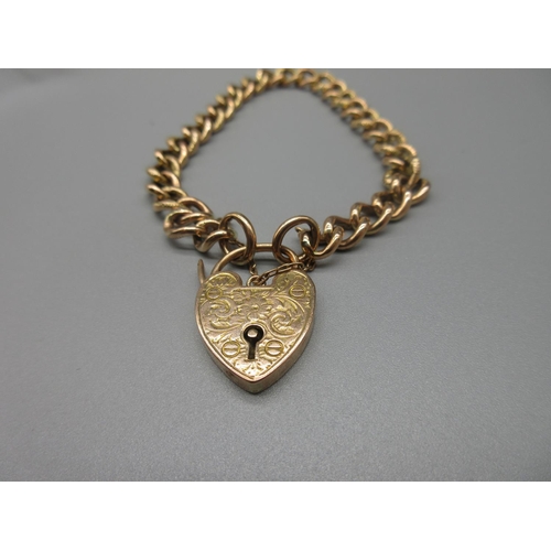18 - 9ct yellow gold chain link bracelet with engraved heart padlock clasp and safety chain, stamped 9ct,... 