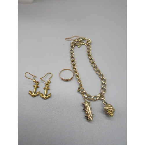 52 - Yellow metal charm bracelet set with two 9ct yellow gold charms, and one yellow metal charm, gross 1... 