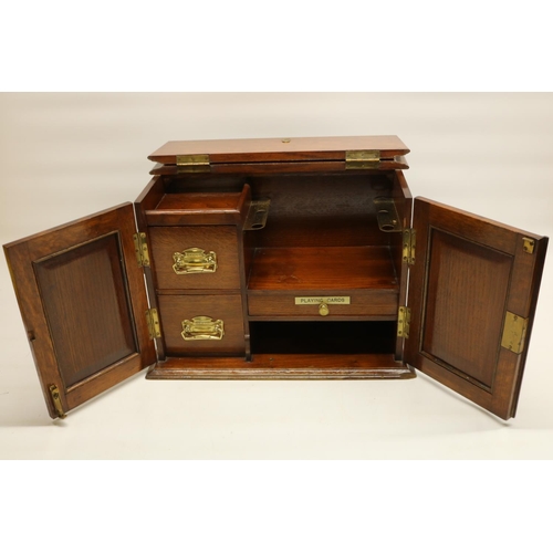 284 - Early C20th oak desktop smoker's cabinet, with two hinged doors inset with Art Nouveau metal panels,... 