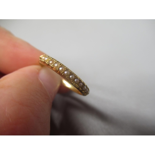 58 - 18ct yellow gold ring set with seed pearls, size N, and a 18ct yellow gold ring with interlinking de... 