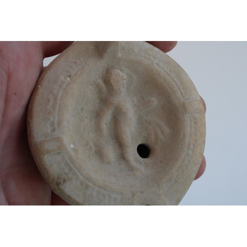 774 - Ancient Cypriot Greco-Roman terracotta oil lamp, central well decorated in relief with a Cherub, 10c... 