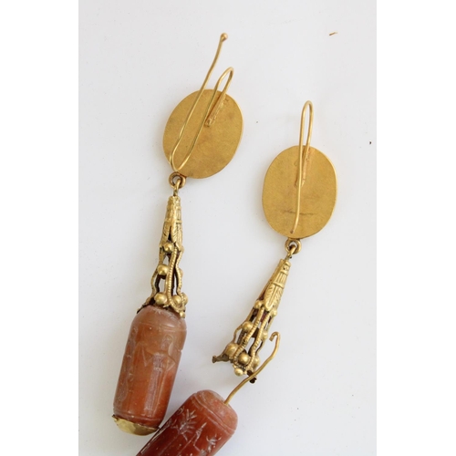 779 - Pair of ancient Cypriot gold drop earrings, the Carnelian bead drops finely etched with standing fem... 