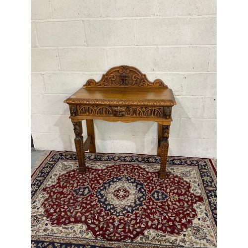 781 - Oak single drawer side table with arched raised back, oakleaf carved legs and drawer with 'Green Man... 