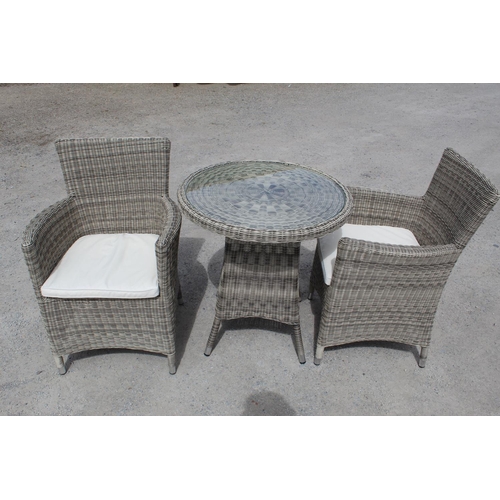 1471 - Rattan conservatory glass topped table W71cm H75cm, and two chairs with cushions approx H90cm W62cm