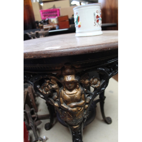 1477 - Cast metal three legged pub table with pine circular top the ornate design to legs including Britann... 