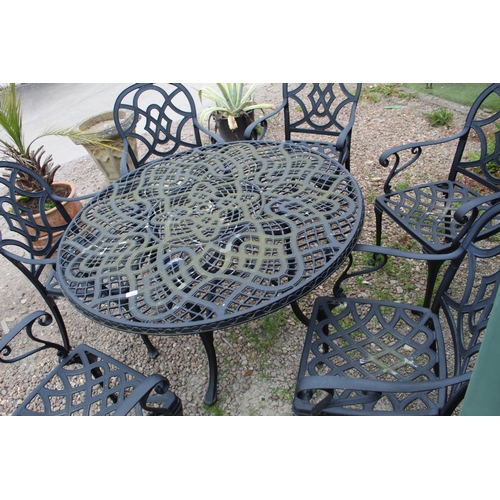 1466 - Large garden circular metal table with pierced work design on four legs with central stretcher and s... 