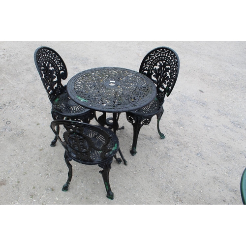 1470 - Cast metal garden circular table with floral and leaf piercing on three legs and with three matching... 