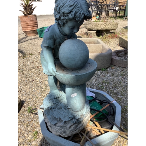 1451 - Fibre glass garden water feature in the form of a young boy over a water feature including pump