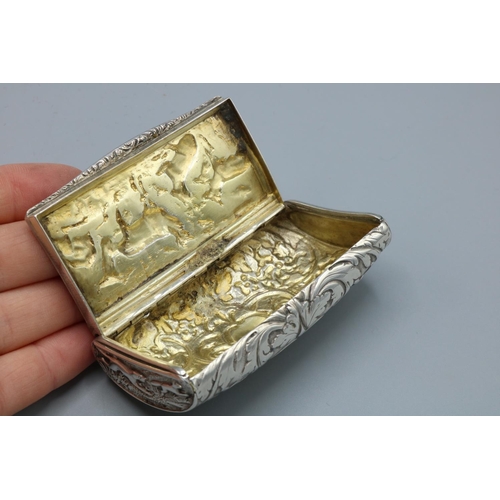 1085 - George V hallmarked silver rectangular snuff box with curved bas, all over repousse with hunting sce... 