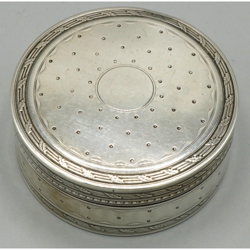 1157 - Continental silver circular pill box, with dot decoration in leaf clasped reeded bands, engine turne... 