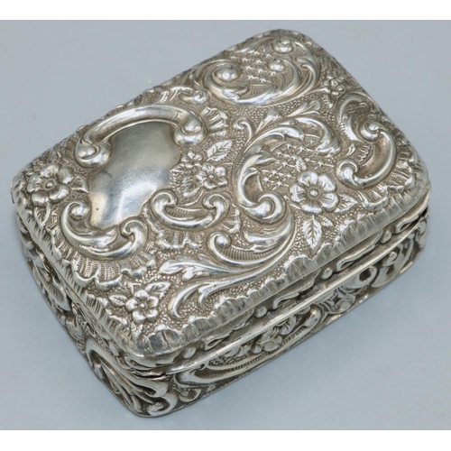 1087 - Victorian hallmarked silver rectangular snuff box, all over repousse with scrolls and cartouche, gil... 