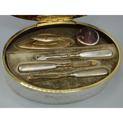 1093 - George V hallmarked silver manicure set, oval with hinged tortoiseshell lid, fitted interior with ja... 