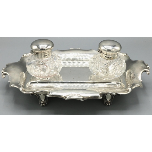 1069 - Edward VII hallmarked silver rectangular inkstand, with scrolled edge on four scroll feet, the two c... 