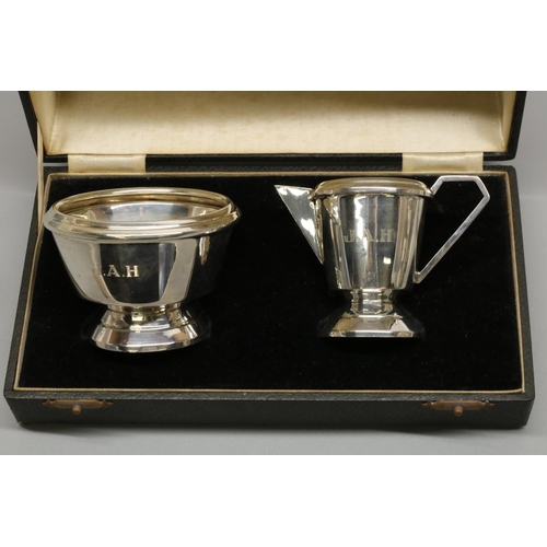 1169 - George V hallmarked silver Art Deco cream jug and sugar bowl, tapering bodies with angular handles o... 